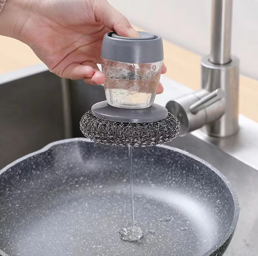 Person using a kitchen scrubber to clean a pot under running water.
