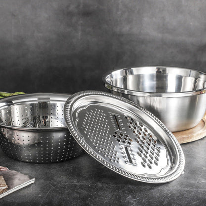 Stainless steel grater and bowl set on a dark surface with a blurred background